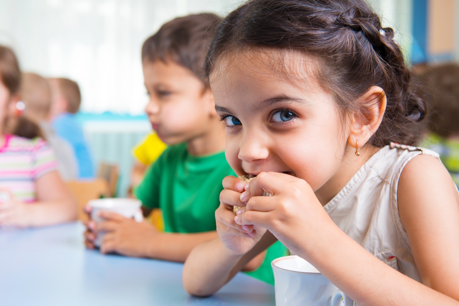 A child eating with family support nearby